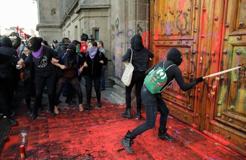 Mexican demonstrators marched toward the Mexican Palace where President Obrador and his family lives and painted re the palace large and ornate door.