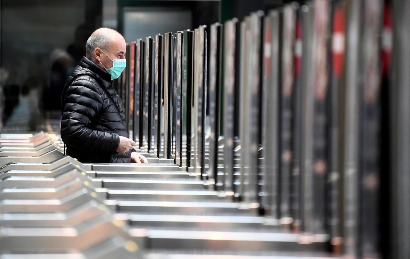 Man in a face mask is seen at the Cadorna railway station in Milan