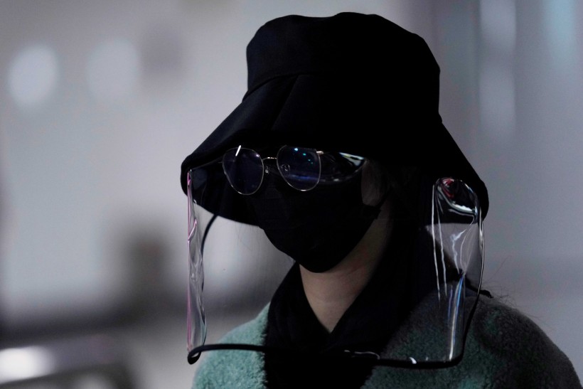 Woman wearing face mask, sunglasses and face shield is seen at a subway station as the country is hit by an outbreak of the novel coronavirus, in Shanghai