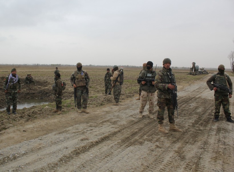 Afghan National Army (ANA) soldiers arrive at the site of last night clashes between Taliban and Afghan forces in Kunduz, Afghanistan