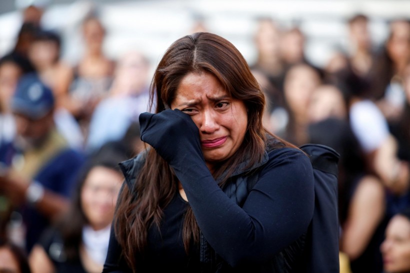 A woman cries as she protests against gender violence and femicides at Angel de la Independencia monument in Mexico City