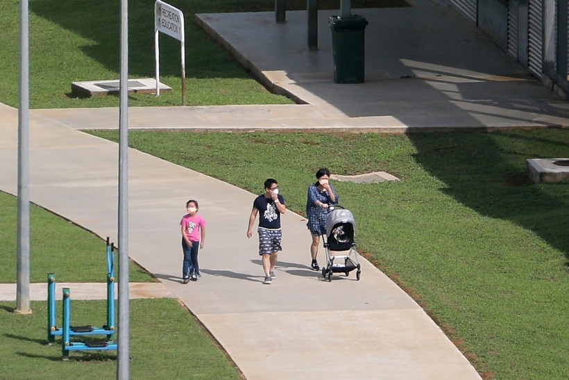 A family of evacuees are seen walking at the Christmas Island Immigration Detention Centre