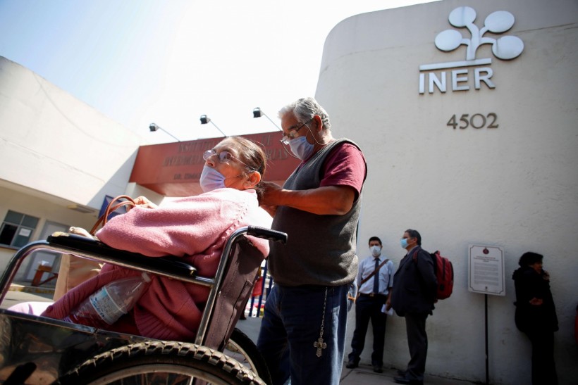 People wearing protective face masks circulate outside the National Institute of Respiratory Diseases where a patient who tested positive for coronavirus is being treated, according to local authorities, in Mexico City