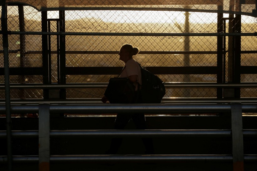 A woman walks towards El Paso, Texas, U.S. at the international border bridge Paso del Norte, as seen from Ciudad Juarez