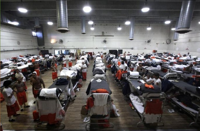 Inmates walk around a gymnasium where they are housed due to overcrowding at the California Institution for Men state prison in Chino, California,