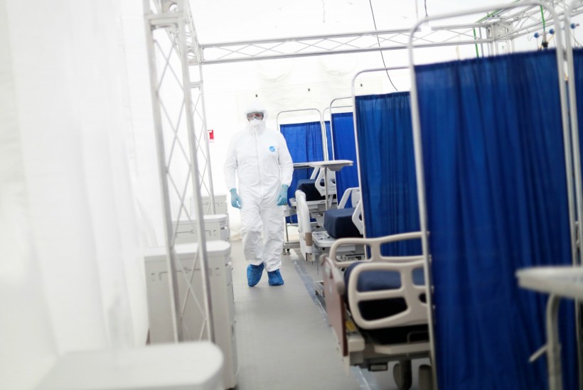 A medical specialist wearing protective gear walks inside the new immediate response mobile hospital in Pachuca