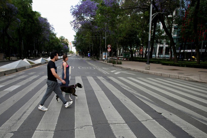 People walk on the street as the coronavirus disease (COVID-19) outbreak continues, in Mexico City,