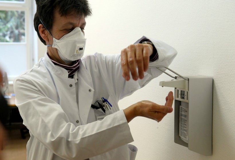 Chief doctor Katja de With wears protection gear and washes her hands during a media event in the newly opened coronavirus disease (COVID-19) clearing-up centre in Dresden