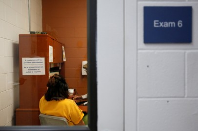 FILE PHOTO: A detainee talks with an employee in an exam room in the medial unit during a media tour at Northwest ICE Processing Center in Tacoma