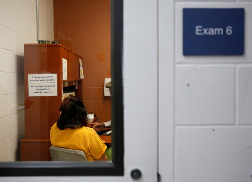 FILE PHOTO: A detainee talks with an employee in an exam room in the medial unit during a media tour at Northwest ICE Processing Center in Tacoma