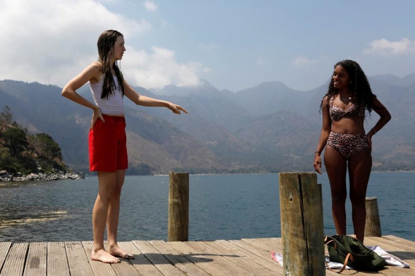 Backpacker and Spanish language student Lola Daehler, from the U.S., talks with her friend after she decided to stay in Guatemala, where she feels safer to confront the outbreak of coronavirus disease (COVID-19), in San Pedro La Laguna, Solola, Guatemala
