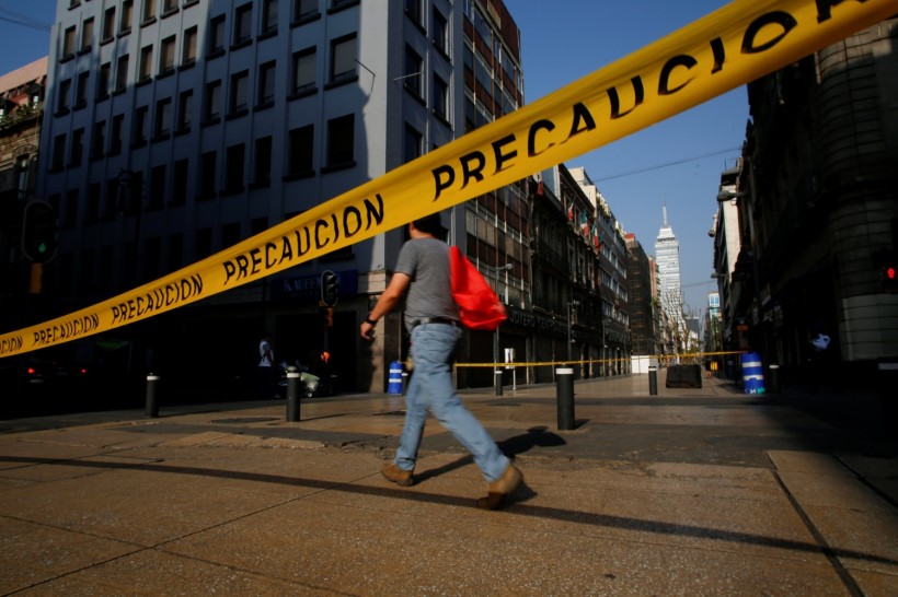 Caution tape blocks off a pedestrian street after Mexico's government declared a health emergency on Monday