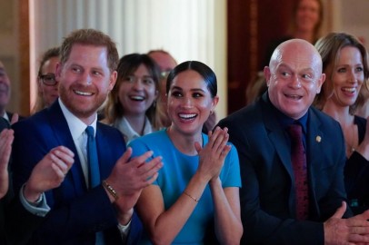 Britain's Prince Harry and his wife Meghan, Duchess of Sussex, sitting next to Ross Kemp, cheer during the annual Endeavour Fund Awards at Mansion House in London. 