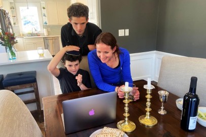 Cheryl Noah and Alex Barkin use a computer during a family Passover Seder to connect with relatives who are unable to gather together due to the outbreak of Coronavirus disease (COVID-19) in Maplewood, New Jersey, U.S