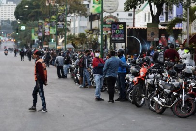 Motorcycle drivers wait in line to the opening of a gas station during a nationwide quarantine due to coronavirus disease (COVID-19) outbreak in Caracas, Venezuela.