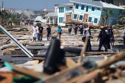 First responders and residents walk along a main street following Hurricane Michael in Mexico Beach, Florida, U.S.