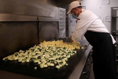 Image: A chef cooks vegetables at the Westin Bonaventure hotel 