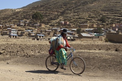 An indigenous woman cycles nears Cohana Bay on the shores of Titicaca lake, some 110 km (68 miles) northwest of La Paz