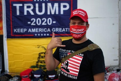 A supporter of U.S. President Donald Trump gestures while wearing a mask outside the BOK Center, the venue for Trump's upcoming rally, in Tulsa, Oklahoma, US.