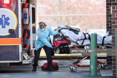 First responders load a patient into an ambulance from a nursing home where multiple people have contracted COID-19 on April 17, 2020 in Chelsea, Massachusetts. Chelsea has the highest concentration o