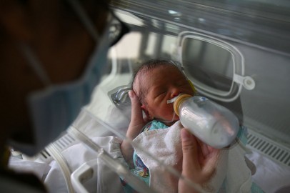 A newborn baby drinks milk at the ICU of Obstetrics and Gynecology Department 