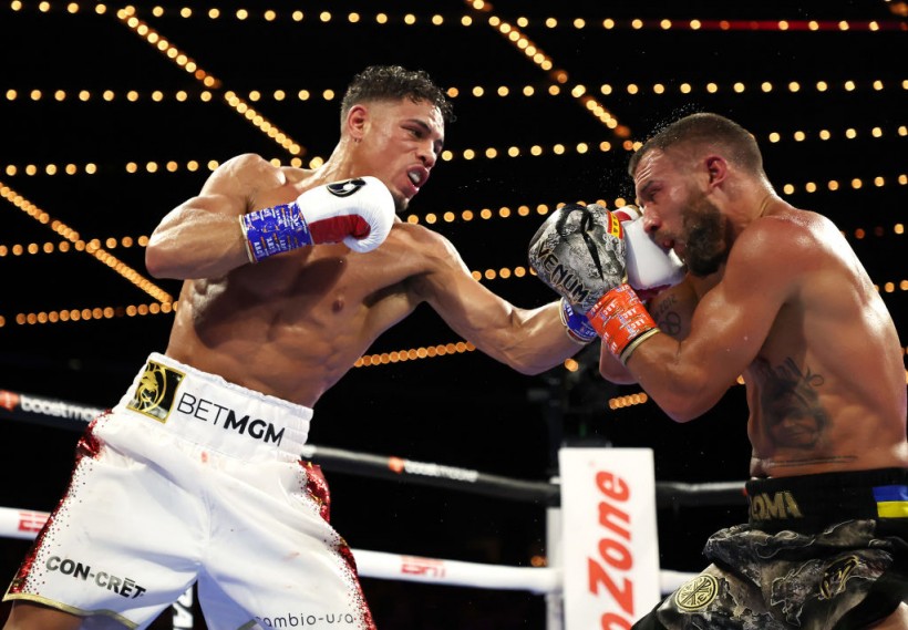 Jamaine Ortiz (left) connects with his left hand during his Oct. 2022 fight vs. Vasyl Lomachenko (right).