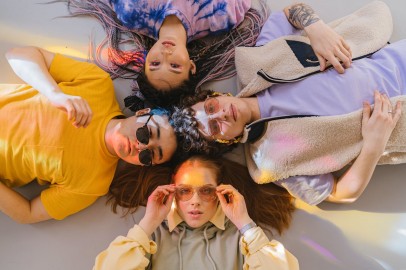 A Group of People Wearing Colorful Clothes Lying on their Backs
