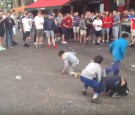 Gypsy children pick up money thrown at them by English soccer fans.