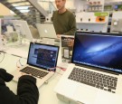 Visitor inspects Mac Book Pro at the Commart Next-Gen 2014 in Bangkok.