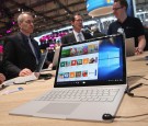 Visitors check out the Surface Book laptop at the Microsoft stand at the 2016 CeBIT digital technology trade fair on the fair's opening day on March 14, 2016 in Hanover, Germany.