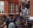 Wikileaks founder Julian Assange speaks from the balcony of the Ecuadorian embassy where he continues to seek asylum following an extradition request from Sweden in 2012, on February 5, 2016 in London