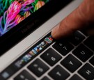 An Apple employee points to the Touch Bar on a new Apple MacBook Pro laptop during a product launch event on October 27, 2016 in Cupertino, California.