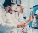 scientists looking at a DNA sequence on the monitor