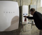 A customer inspects a Tesla Motors Inc. Powerwall unit inside a home in Monkton, Vermont, U.S., on Monday, May 2, 2016