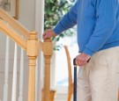 Man suffering from Parkinson's disease and multiple sclerosis standing near steps