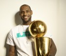 Portrait of Miami Heat LeBron James casual, posing with Larry O'Brien Championship Trophy during photo shoot at Four Seasons Hotel. Miami, FL.