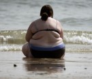 A woman sits at the water's edge as she enjoys the hot weather on the sea front on April 14 in Bournemouth, England.