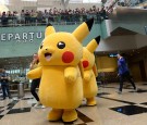 Performers dressed as the Pokemon Go virtual reality game mascot Pikachu take part in a parade during a promotional event at Changi International airport terminal in Singapore on November 18, 2016. Hundreds of Pokemon fans gathered at Changi Airport's Ter