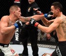 (L-R) Anthony Pettis punches Max Holloway in their interim UFC featherweight championship bout during the UFC 206 event inside the Air Canada Centre on December 10, 2016 in Toronto, Ontario, Canada.