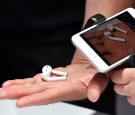 A person takes a photo of a set of wireless Apple AirPods during a media event at Bill Graham Civic Auditorium in San Francisco, California on September 07, 2016.