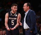 Matt Farrell #5 of the Notre Dame Fighting Irish talks with head coach Mike Brey 