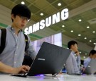 A visitor tries out a Samsung Electronics Co. Series 7 Chronos laptop computer at the World IT Show 2013 in Seoul, South Korea, on Tuesday, May 21, 2013.