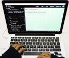  student writes code for the rock-paper-scissors game on an Apple Inc. laptop computer during a coding class at the First Code Academy in Hong Kong, China, on Friday, Nov. 13, 2015. About 2,500 students have taken courses at the First Code Academy.