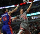 Paul Zipser #16 of the Chicago Bulls puts up a shot past Boban Marjanovic #51 of the Detroit Pistons at the United Center on December 19, 2016 in Chicago, Illinois. 