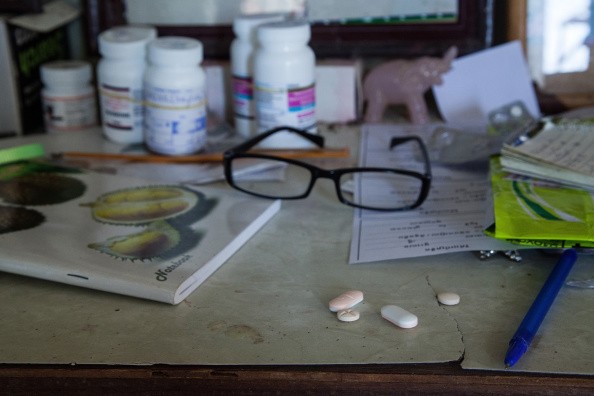 HIV medication is seen on a table inside one of the houses of the community on September 6, 2014 in Tuol Sambo, Cambodia. 
