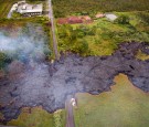 In this handout provided by the U.S. Geological Survey (USGS), The June 27th lava flow covers view of the flow over Cemetery Rd./Apa'a St.on October 29, 2014 in Pahoa, Hawaii.