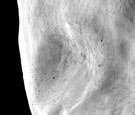 The European Space Agency, transmitted by the space craft Rosetta, shows a close-up view of a possible landslide and boulders at the highest resolution on the asteroid Lutetia.