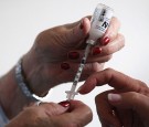 Registered nurse Susan Eager (R) teaches a diabetic patient how to draw her own insulin injections during a house call on March 26, 2012 in Denver, Colorado.