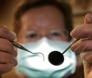 A patient's eye view, as a dentist poses for the photographer on April 19, 2006 in Great Bookham, England. 