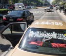 People attach signs to cars protesting an increase in gas prices, during a protest organized by the Morena Political party, on January 4, 2017 in Mexico City, Mexico.